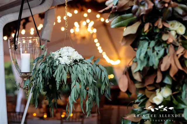 Hanging candle and greenery under string lights
