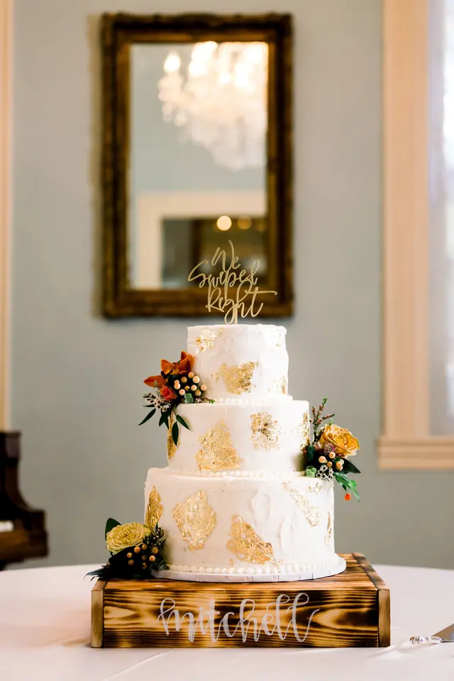 Three-tier cake in front of a gilt mirror