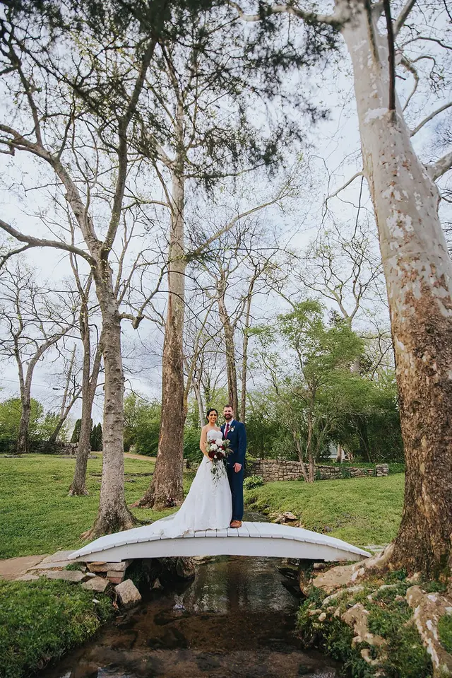 Couple on the footbridge among tall bare trees