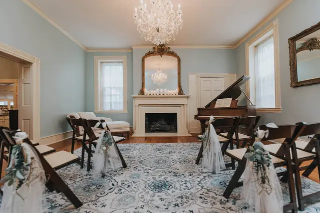 Parlor set with rows of chairs for an indoor ceremony
