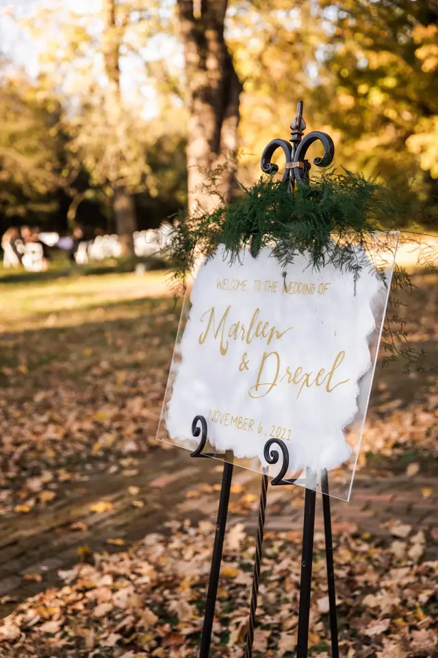 Welcome sign on an easel among autumn leaves