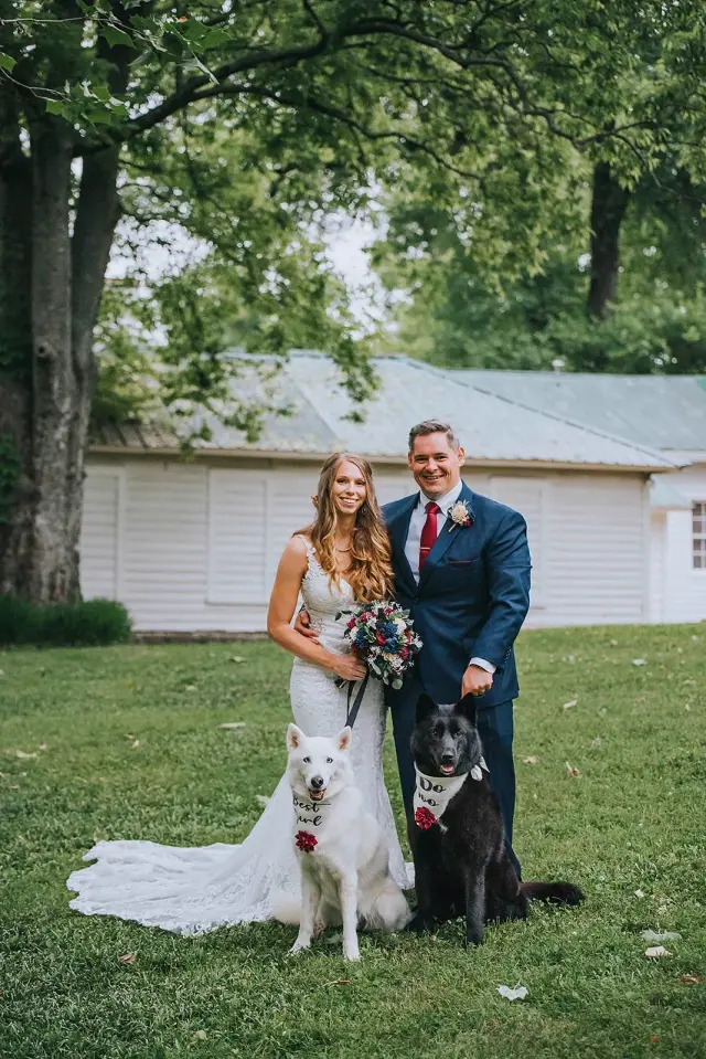 Couple on the lawn with their two dogs